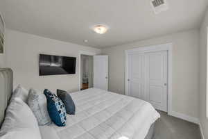 Bedroom with carpet and a closet