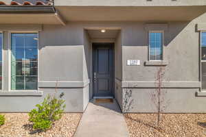 Property entrance featuring stucco siding