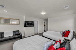 Bedroom with carpet and a walk in closet