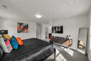 Bedroom with carpet flooring and ensuite bathroom