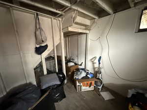 Unfinished below grade area featuring dark wood-type flooring