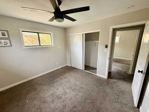 Unfurnished bedroom featuring carpet, a ceiling fan, and a closet