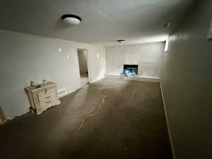 Basement with a fireplace and carpet