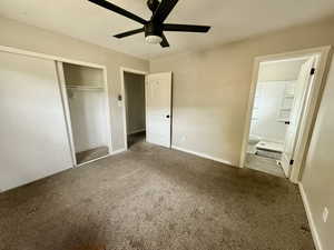 Unfurnished bedroom with carpet floors, a closet, ceiling fan, and ensuite bathroom