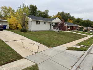 Ranch-style house with brick siding and a front yard