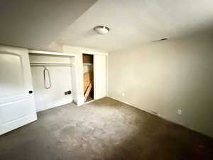 Unfurnished bedroom with carpet floors and a closet