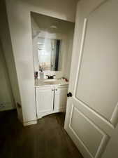Bathroom with vanity and dark wood-type flooring