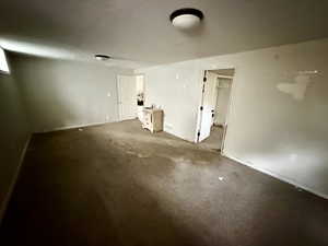 Empty room with baseboards and carpet floors