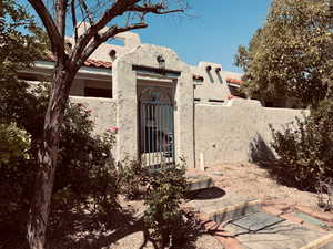 View of front of property featuring a gate