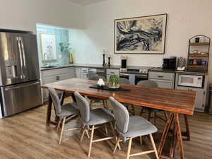 Dining space featuring light wood-style floors and a textured wall