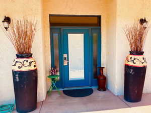 Entrance to property with stucco siding