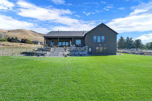 Back of house featuring a patio, a mountain view, and stucco siding
