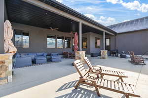 View of patio with outdoor lounge area, outdoor dining area, and ceiling fan