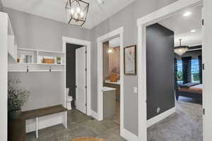Mudroom with a chandelier, carpet, and recessed lighting