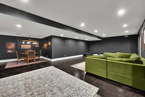 Home theater room with concrete flooring and recessed lighting