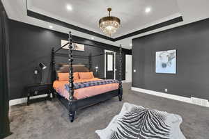 Bedroom with a raised ceiling, carpet flooring, crown molding, recessed lighting, and a chandelier