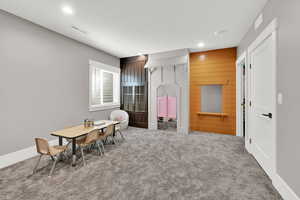 Recreation room that has walk in closet, could be used for bedroom, featuring carpet floors and recessed lighting
