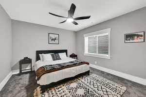 Carpeted bedroom with baseboards and ceiling fan