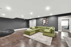 Living area with finished concrete flooring and recessed lighting