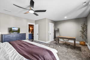 Basement Master Bedroom featuring carpet flooring, a ceiling fan, ensuite bathroom, and an office area