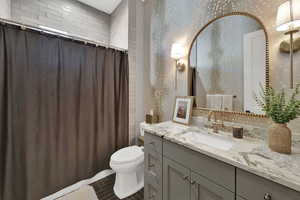 Full bathroom with vanity and dark tile patterned flooring