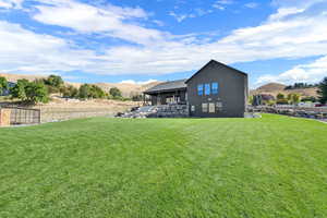 Rear view of property featuring a mountain view, a view of countryside, and a patio