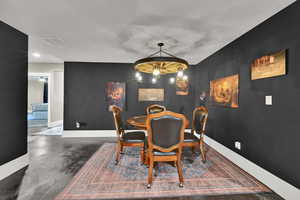 Dining space featuring concrete floors and baseboards