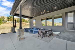 View of patio with outdoor lounge area, outdoor dining area, a mountain view, and a ceiling fan