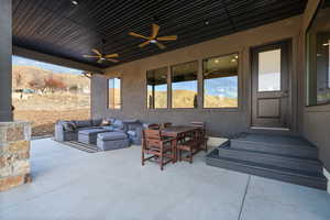 View of patio / terrace with outdoor dining area, an outdoor living space, a mountain view, and a ceiling fan