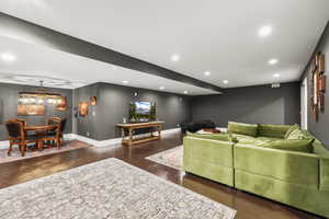 Living area with recessed lighting and finished concrete flooring