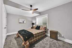 Carpeted bedroom with baseboards and a ceiling fan