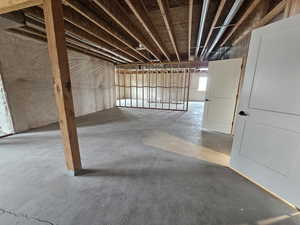 Miscellaneous room with unfinished concrete flooring
