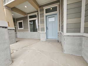 View of exterior entry featuring a porch