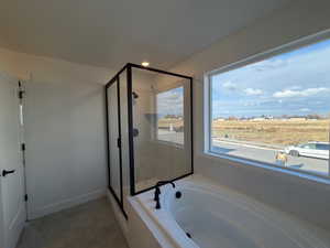 Full bathroom featuring a shower stall, a bath, light tile patterned floors, and recessed lighting