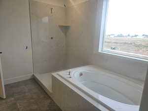 Bathroom with a bath and a walk in shower