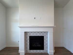 Detailed view of a fireplace and wood finished floors