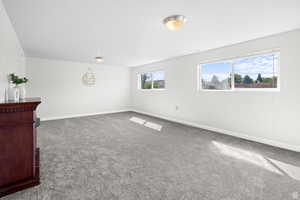Empty room featuring carpet floors and baseboards