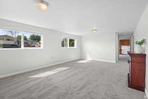 Carpeted empty room with plenty of natural light and a textured ceiling