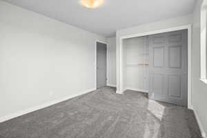 Unfurnished bedroom featuring light colored carpet and a closet