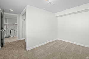 Unfurnished room featuring light colored carpet and recessed lighting