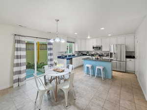 Open floor plan with spacious white kitchen, tile flooring, granite countertops, two-story great room and walk-in pantry
