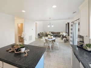 Open floor plan featuring a two-story great room plus large kitchen with center island, granite counters and fresh neutral paint