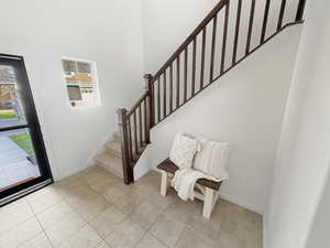 Two-Story Entry with tile flooring and neutral fresh paint