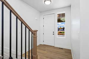 Foyer entrance featuring stairway and light wood-type flooring