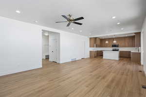 Unfurnished living room with recessed lighting, light wood-style flooring, and ceiling fan