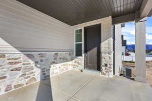 Doorway to property featuring stone siding and a mountain view