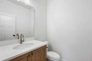 Half bath with vanity and toilet