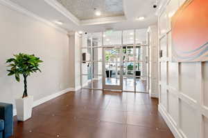 Common area with ornamental molding, expansive windows, and recessed lighting