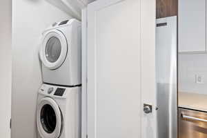 Washroom with stacked washer and clothes dryer