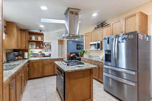 Kitchen with appliances with stainless steel finishes, a peninsula, light stone countertops, light tile patterned flooring, and recessed lighting